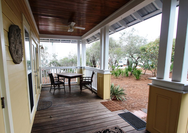 Spacious back porch with ceiling fan