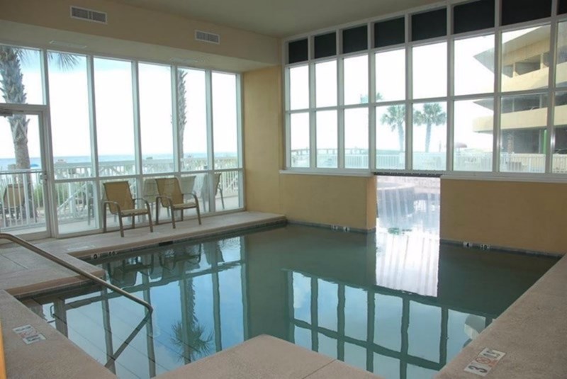 Indoor swimming pool leading to the outside.