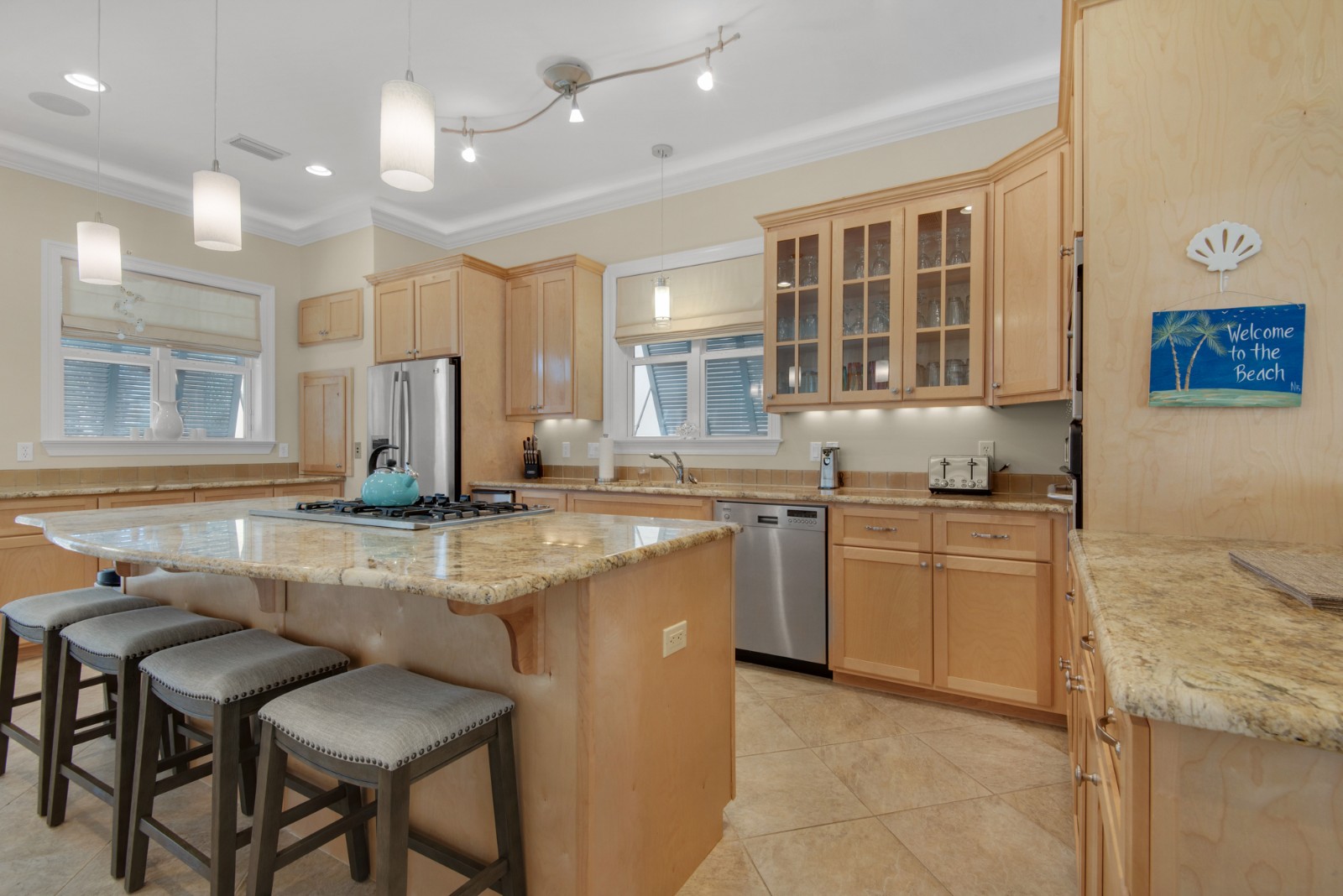 Well appointed kitchen features granite counters and stainless appliances