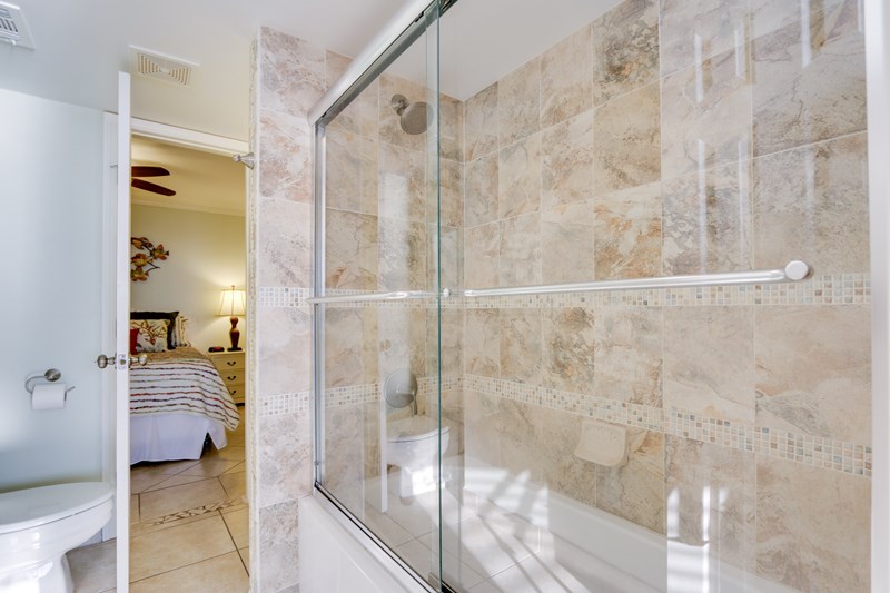 Beautifully tiled shower surround with glass doors